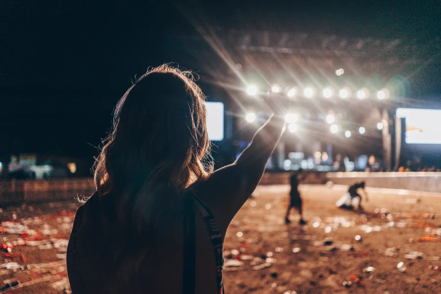 Festival-goer reaching towards the main stage