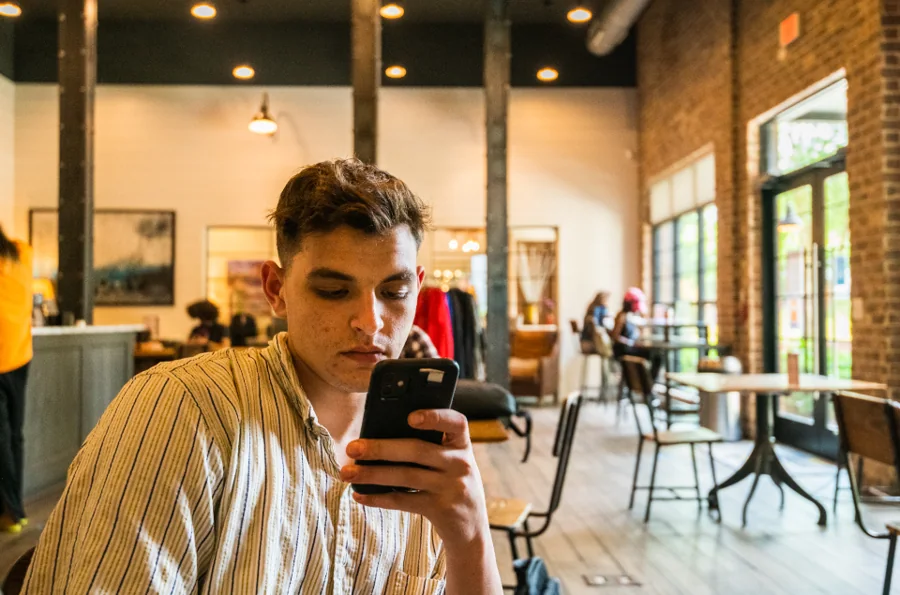 Young man checking his phone in a café